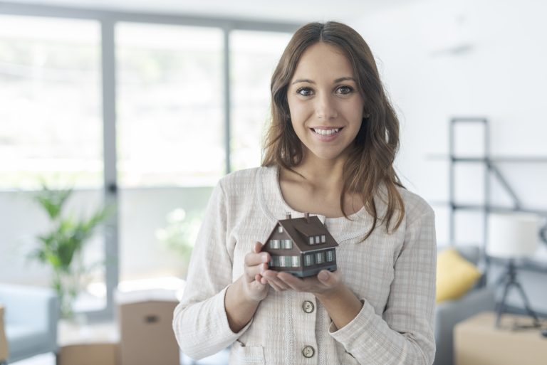 happy woman holding a model house in her new home 2025 01 08 02 26 41 utc Your First Real Estate Investment: Understanding the "Direct Method"